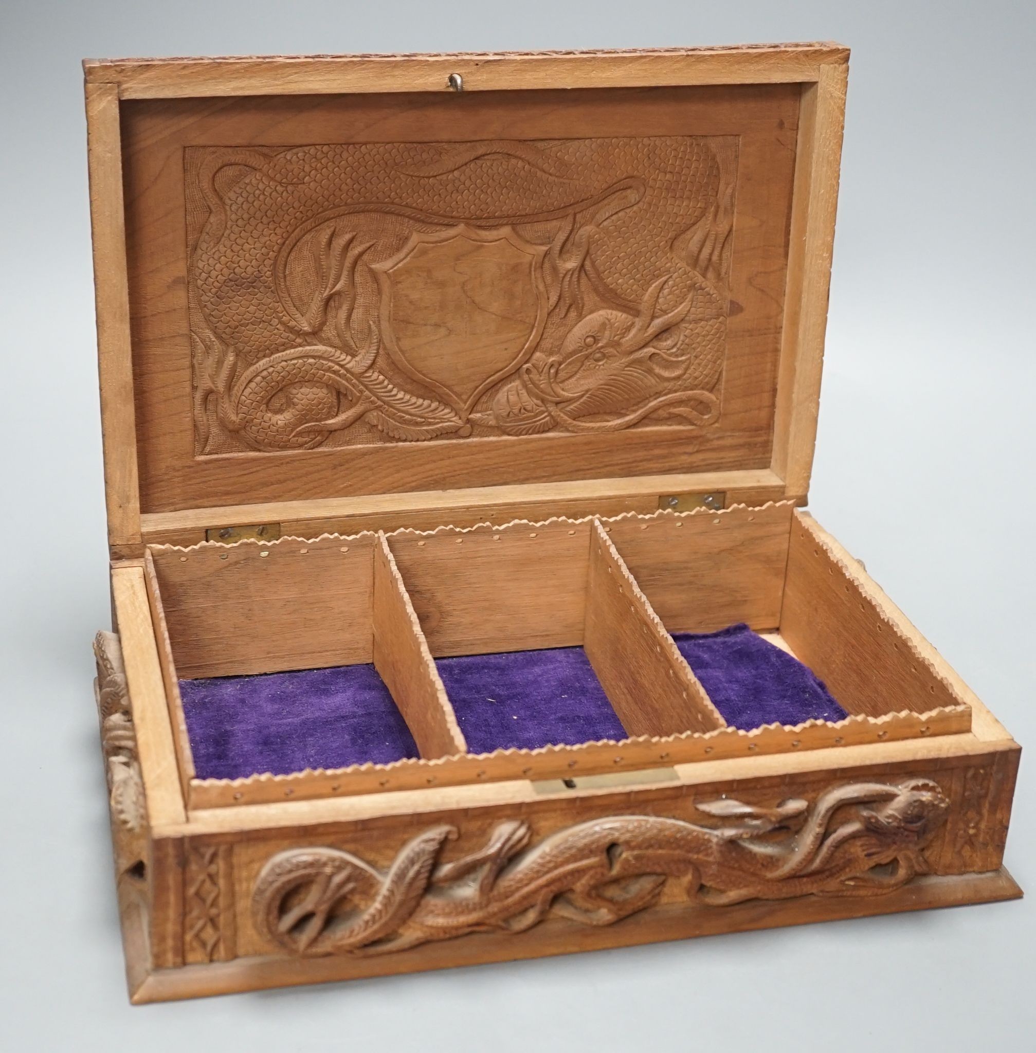 A Burmese carved wood 'Dragon' box, 31cm wide